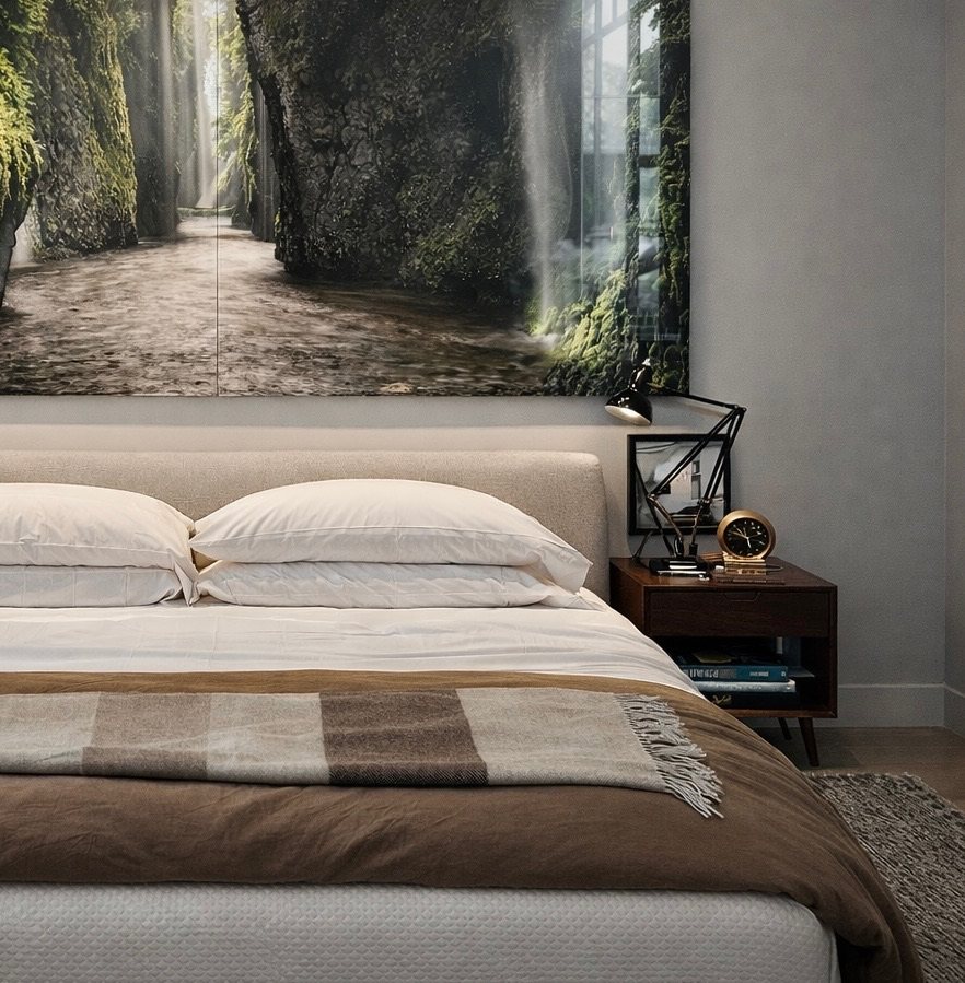 Bedroom with an upholstered headboard and a large photograph of the Columbia River Gorge above the bed