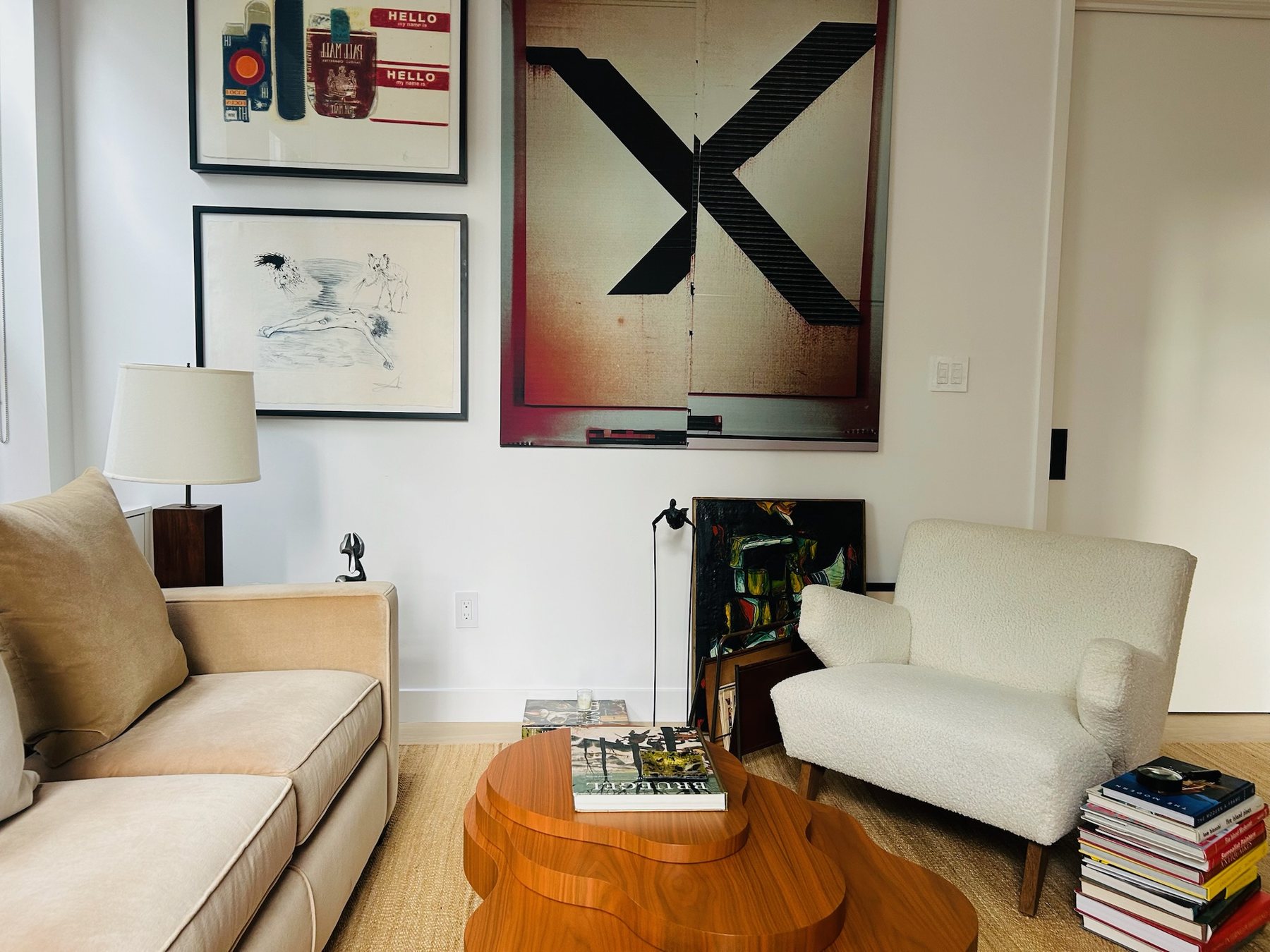 Living room seating group beneath a large black X painting