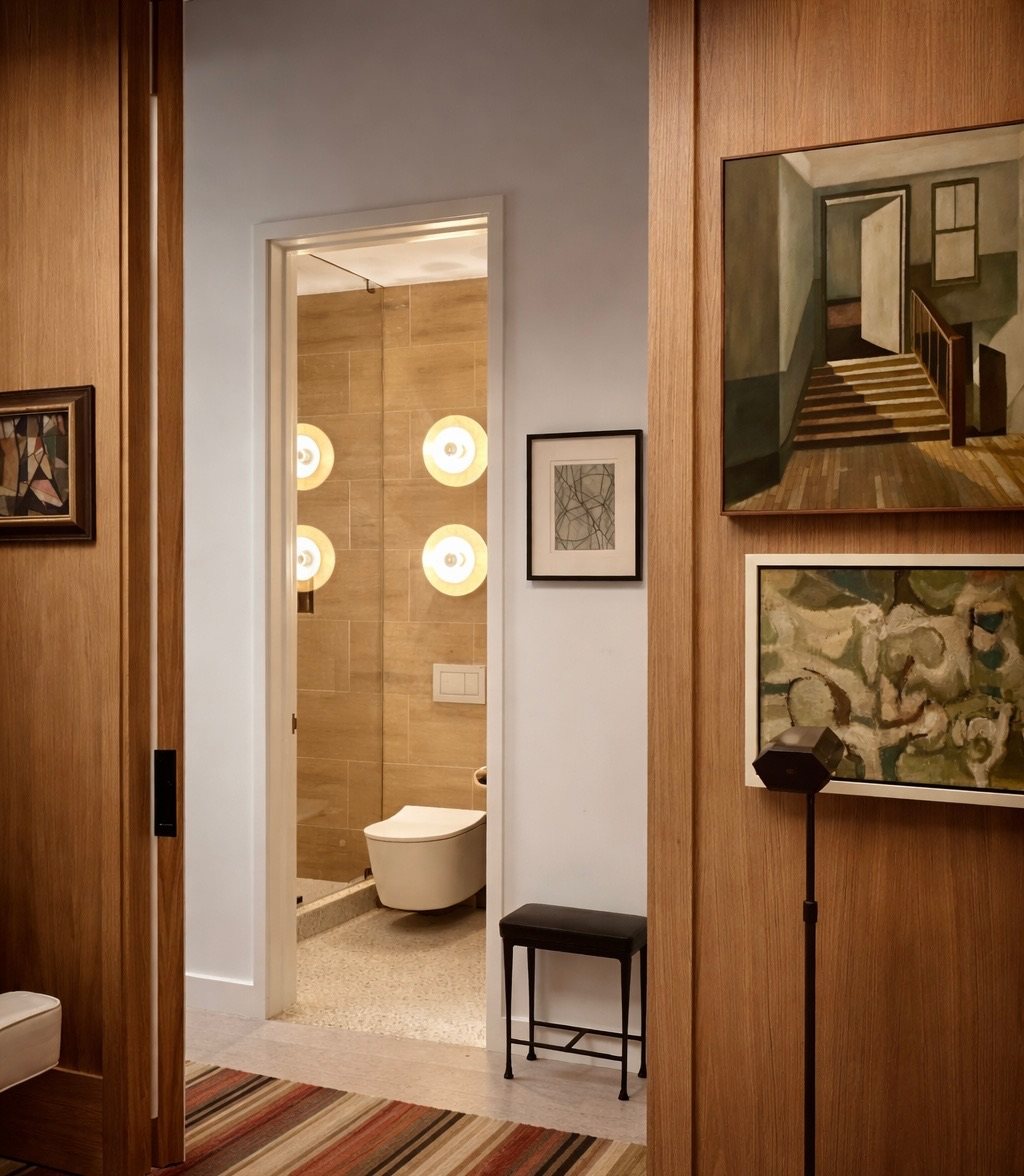 Oak-panelled hallway looking through to a stone powder room